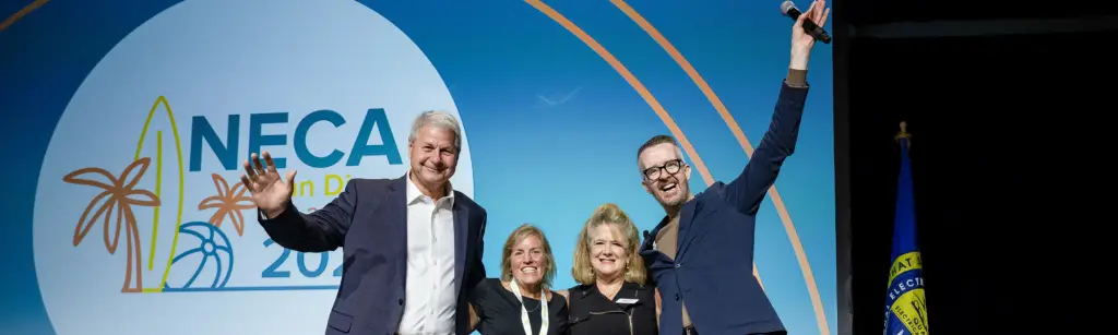 David Meade on stage at NECA 2024 in San Diego, celebrating with industry leaders and the executive team after delivering a high-energy keynote.